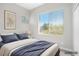 Bright bedroom featuring a large window offering a view and a tufted headboard at 913 Duckhorn Ct # 201, Las Vegas, NV 89144