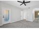 Spacious bedroom with gray carpet, ceiling fan, and direct access to the bathroom at 913 Duckhorn Ct # 201, Las Vegas, NV 89144
