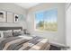 Bedroom with large window allowing natural light and a comfortable bed at 913 Duckhorn Ct # 201, Las Vegas, NV 89144