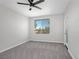 Bright bedroom featuring a ceiling fan, large window, and a private door at 913 Duckhorn Ct # 201, Las Vegas, NV 89144