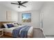 Bedroom with wood trim and a large window with a view to the exterior at 913 Duckhorn Ct # 201, Las Vegas, NV 89144