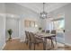 Dining room featuring wood floors, modern light fixture and balcony access at 913 Duckhorn Ct # 201, Las Vegas, NV 89144