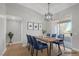 Dining room featuring wood floors, modern light fixture and balcony access at 913 Duckhorn Ct # 201, Las Vegas, NV 89144