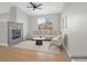 Bright living room features a fireplace, vaulted ceiling with fan, and view to the exterior at 913 Duckhorn Ct # 201, Las Vegas, NV 89144