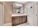 Functional bathroom with double sinks, wood cabinets, and a glass-enclosed shower offers style and convenience at 9217 Valley Betica Ave, Las Vegas, NV 89148