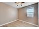 Neutral bedroom with ceiling fan, plank flooring, and window with natural light at 9217 Valley Betica Ave, Las Vegas, NV 89148