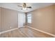 Bedroom offers wood-look vinyl plank flooring, a ceiling fan, and a window for natural light at 9217 Valley Betica Ave, Las Vegas, NV 89148