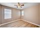 Bedroom offering wood-look vinyl plank flooring, a ceiling fan, and two windows for natural light at 9217 Valley Betica Ave, Las Vegas, NV 89148