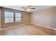 Bright bedroom features light-colored wood floors, two windows, and a ceiling fan at 9217 Valley Betica Ave, Las Vegas, NV 89148