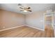 Bright bedroom features light-colored wood floors, neutral colored walls, and a ceiling fan at 9217 Valley Betica Ave, Las Vegas, NV 89148