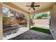 Covered patio with ceiling fan overlooks a backyard with artificial turf and landscaping at 9217 Valley Betica Ave, Las Vegas, NV 89148