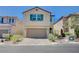 Charming two-story home with an attached two-car garage and well-manicured front yard at 9217 Valley Betica Ave, Las Vegas, NV 89148
