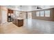 Spacious kitchen and living room area features stainless steel appliances and tile floors at 9217 Valley Betica Ave, Las Vegas, NV 89148