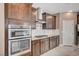 Gourmet kitchen with stainless steel appliances, including double ovens and gas cooktop at 9217 Valley Betica Ave, Las Vegas, NV 89148