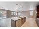 Beautiful kitchen island with stainless dishwasher with an open floor plan and backyard access at 9217 Valley Betica Ave, Las Vegas, NV 89148