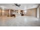 Open-concept living room and kitchen features tile floors and stainless steel appliances at 9217 Valley Betica Ave, Las Vegas, NV 89148