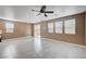 Open living room area features neutral paint, tile floors and lots of light from large windows at 9217 Valley Betica Ave, Las Vegas, NV 89148