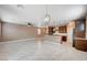 Spacious living room area open to the kitchen features tile floors and ample natural light at 9217 Valley Betica Ave, Las Vegas, NV 89148