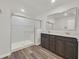 Bathroom showcasing a glass-enclosed shower, marble countertops, and dark wood cabinets at 9327 Ettrick Ct, Las Vegas, NV 89178