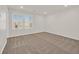 This carpeted bedroom has natural light from windows with shutter style blinds at 9327 Ettrick Ct, Las Vegas, NV 89178