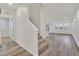 Bright foyer with hardwood flooring, staircase, and view of open floor plan and natural light at 9327 Ettrick Ct, Las Vegas, NV 89178