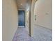 An inviting, covered front door entry with brick walkway and stone-covered landscaping at 9327 Ettrick Ct, Las Vegas, NV 89178