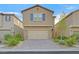Charming two-story home featuring a two-car garage, brick driveway, and manicured landscaping at 9327 Ettrick Ct, Las Vegas, NV 89178