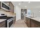 Beautiful kitchen featuring stainless steel appliances, stylish cabinetry, and a large island with quartz countertops at 9327 Ettrick Ct, Las Vegas, NV 89178