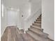 Carpeted staircase with white railing leads to the upper level, complemented by wood-look flooring at 9327 Ettrick Ct, Las Vegas, NV 89178