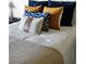 Close up of a beautifully styled bedroom with decorative pillows and a cozy knit blanket at 9430 Laguna Niguel Dr # 203, Las Vegas, NV 89134