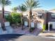 Exterior showcases manicured landscaping and multiple townhouses, each with its own garage at 9430 Laguna Niguel Dr # 203, Las Vegas, NV 89134