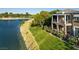 Beautiful house exterior view from the lake with a balcony and luscious green grass at 9430 Laguna Niguel Dr # 203, Las Vegas, NV 89134