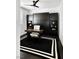 Sleek home office featuring built-in cabinets, a modern ceiling fan, and stylish black and white rug at 9430 Laguna Niguel Dr # 203, Las Vegas, NV 89134
