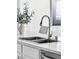 Close-up of a stainless steel kitchen sink with modern faucet and white countertop, perfect for meal preparation at 9430 Laguna Niguel Dr # 203, Las Vegas, NV 89134