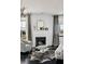 Inviting living room featuring a fireplace, zebra-print rug and neutral modern furniture and fixtures at 9430 Laguna Niguel Dr # 203, Las Vegas, NV 89134