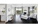 Open-concept living room with fireplace, dark floors, and an outdoor balcony at 9430 Laguna Niguel Dr # 203, Las Vegas, NV 89134