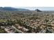 Panoramic aerial shot of a neighborhood, featuring mature trees, desert landscaping, and picturesque mountain views at 9513 Yucca Blossom Dr, Las Vegas, NV 89134