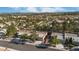 Community aerial showcasing well-maintained homes with tile roofs, lush trees, and scenic views at 9513 Yucca Blossom Dr, Las Vegas, NV 89134
