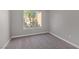 Empty bedroom with fresh paint, clean carpet, and a large window bringing in natural light at 9513 Yucca Blossom Dr, Las Vegas, NV 89134