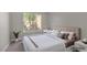 Bedroom featuring neutral colors, soft carpet, a large window, and virtual staging at 9513 Yucca Blossom Dr, Las Vegas, NV 89134