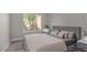 Serene bedroom with a large window, plush bedding, and a minimalist aesthetic for a peaceful retreat at 9513 Yucca Blossom Dr, Las Vegas, NV 89134