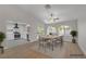 Inviting dining room with hardwood floors, an open-concept kitchen, and a modern dining set at 9513 Yucca Blossom Dr, Las Vegas, NV 89134