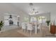 Bright dining room featuring modern white table and chairs, seamlessly flowing into the kitchen with white cabinets at 9513 Yucca Blossom Dr, Las Vegas, NV 89134