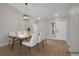 Bright dining room features a modern table set with white chairs and a contemporary light fixture at 9513 Yucca Blossom Dr, Las Vegas, NV 89134