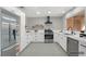 Updated kitchen with stainless steel appliances, white cabinets and an ornate tile floor at 9513 Yucca Blossom Dr, Las Vegas, NV 89134