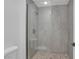 Modern shower featuring beautiful grey stonework, glass doors, and modern fixtures at 9513 Yucca Blossom Dr, Las Vegas, NV 89134