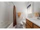 Functional bathroom with a tiled shower, a sink with wooden cabinets, and neutral decor at 9604 Summer Cypress St, Las Vegas, NV 89123