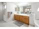 Bathroom featuring double sink vanity with neutral counters, cabinet, and tub at 9604 Summer Cypress St, Las Vegas, NV 89123