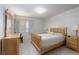 Bright bedroom with wooden furniture, including a dresser and bed, complemented by neutral walls and carpet at 9604 Summer Cypress St, Las Vegas, NV 89123