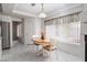Inviting breakfast nook features a wood table, white chairs, and natural light for a cozy dining space at 9604 Summer Cypress St, Las Vegas, NV 89123
